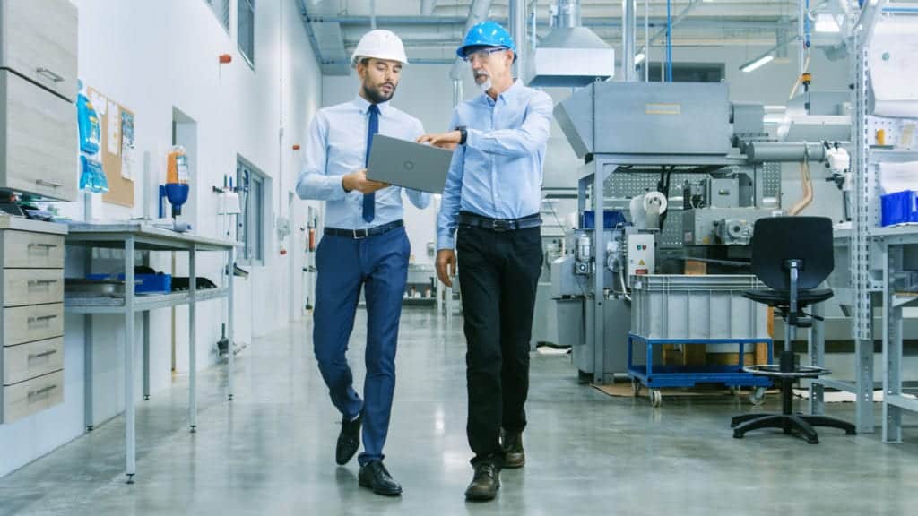 Two product engineers working on medical device development in a factory 